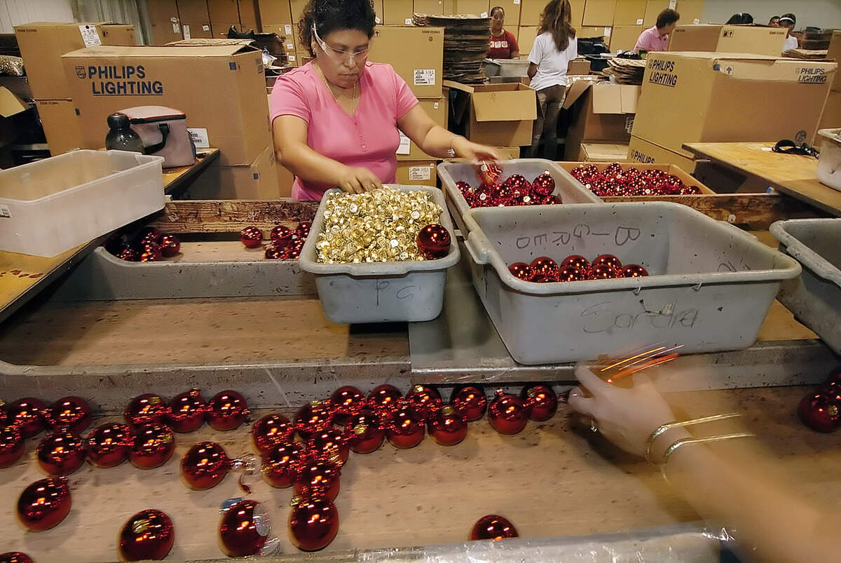 An assembly line worker at Gastonia’s Rauch Industries puts tops on ornaments in this 2005 file photo.  