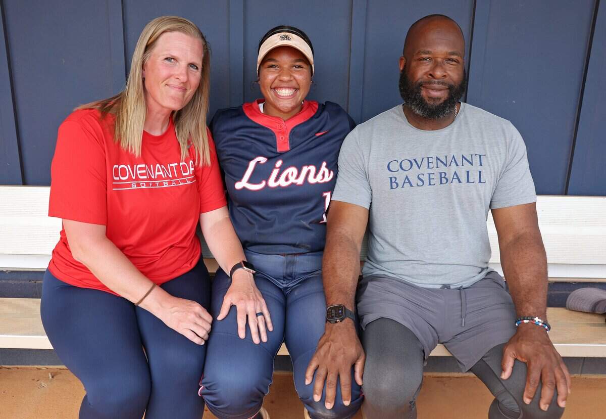 Covenant Day softball player Avery Houseton, center, with her parents Ashley, left and David, right, on Wednesday, April 1, 2026. Houseton is planning on playing softball for the Charlotte 49ers.