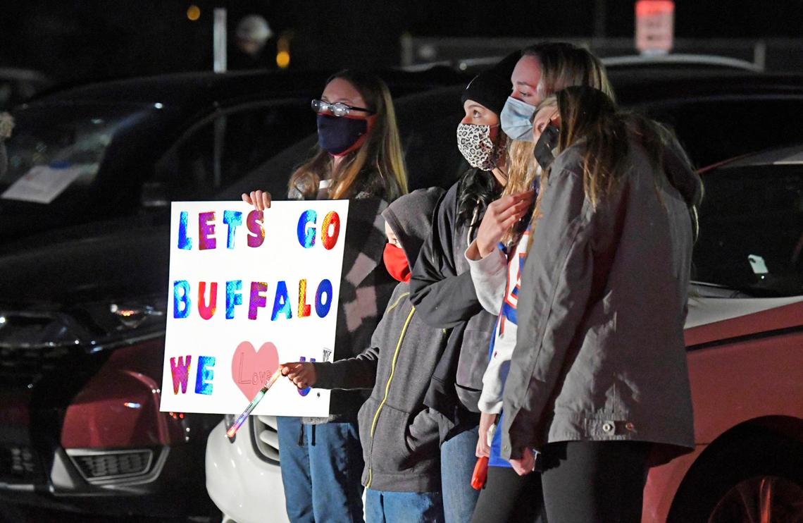Students hold a “Let’s Go Buffalo” sign in honor of Jamie Seitz, the beloved Lincoln Charter School teacher and coach who died of COVID-19, during a memorial service at the school in Denver, NC on Wednesday.