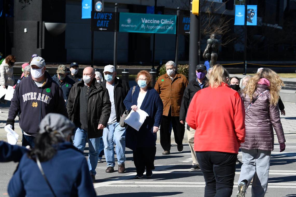Pedestrians leaved the Atrium Health vaccine clinic hosted at Bank of America Stadium on Friday, January 29, 2021. Atrium Health, Honeywell, Tepper Sports & Entertainment and Charlotte Motor Speedway formed a public-private partnership that expects to vaccinate 19,000 people at the Friday through Sunday event.