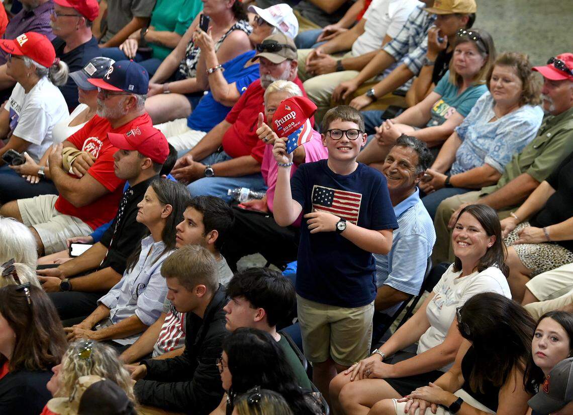 12-year-old Henry James of Huntersville, NC waves his hat as Vice President JD Vance gives a speech.