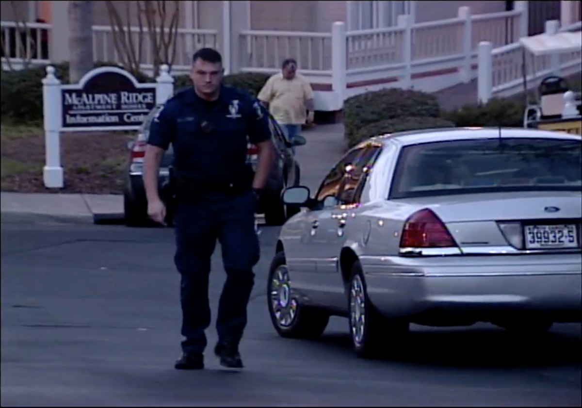 A Charlotte-Mecklenburg police officer photographed on the scene at McAlpine Ridge apartments shortly after Jeffrey Manchester’s 2005 arrest.