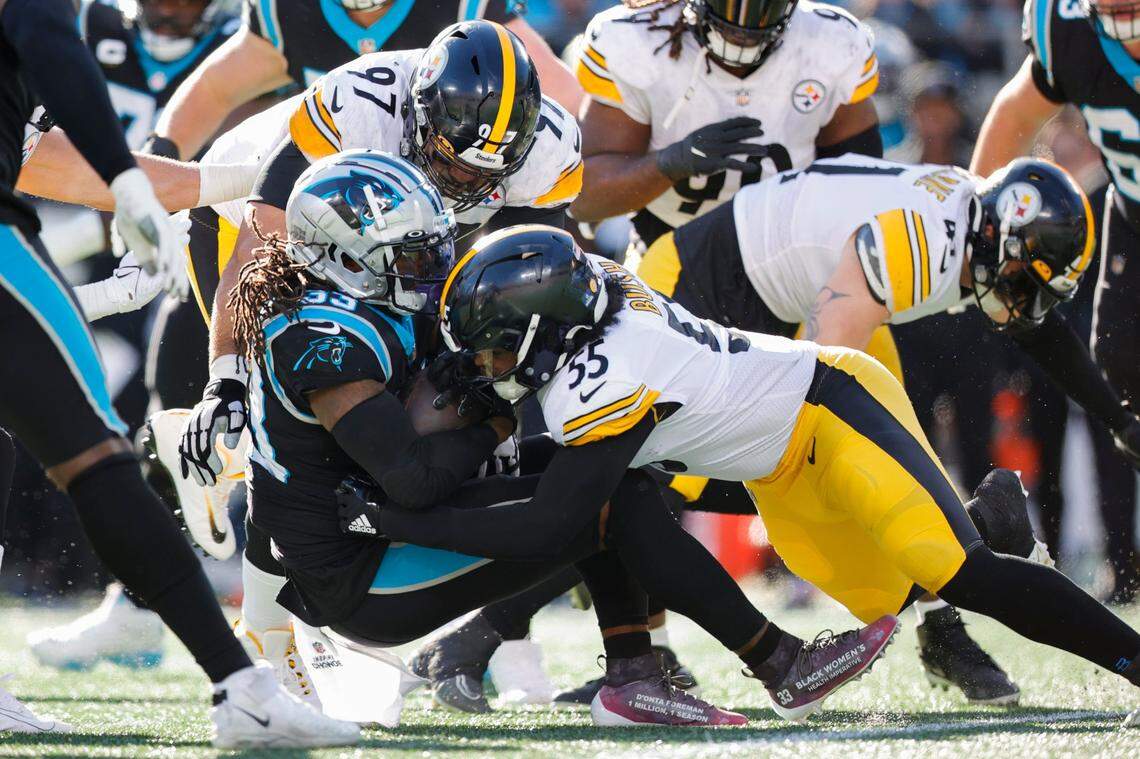 Carolina Panthers running back D’Onta Foreman (33) is stooped by Pittsburgh Steelers linebacker Devin Bush (55) and Pittsburgh Steelers defensive tackle Cameron Heyward (97) during a game at Bank of America Stadium in Charlotte, N.C., Sunday, Dec. 18, 2022.