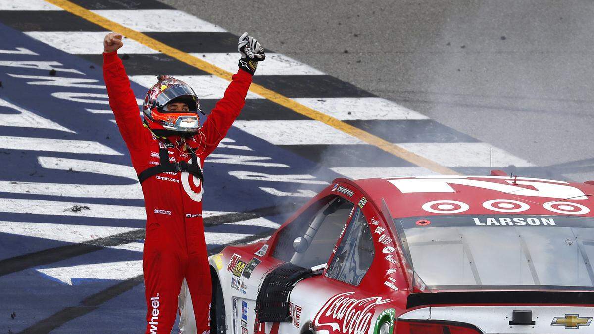 Kyle Larson celebrates winning a NASCAR Cup Series auto race in Brooklyn, Mich., Sunday, Aug. 13, 2017. (AP Photo/Paul Sancya)