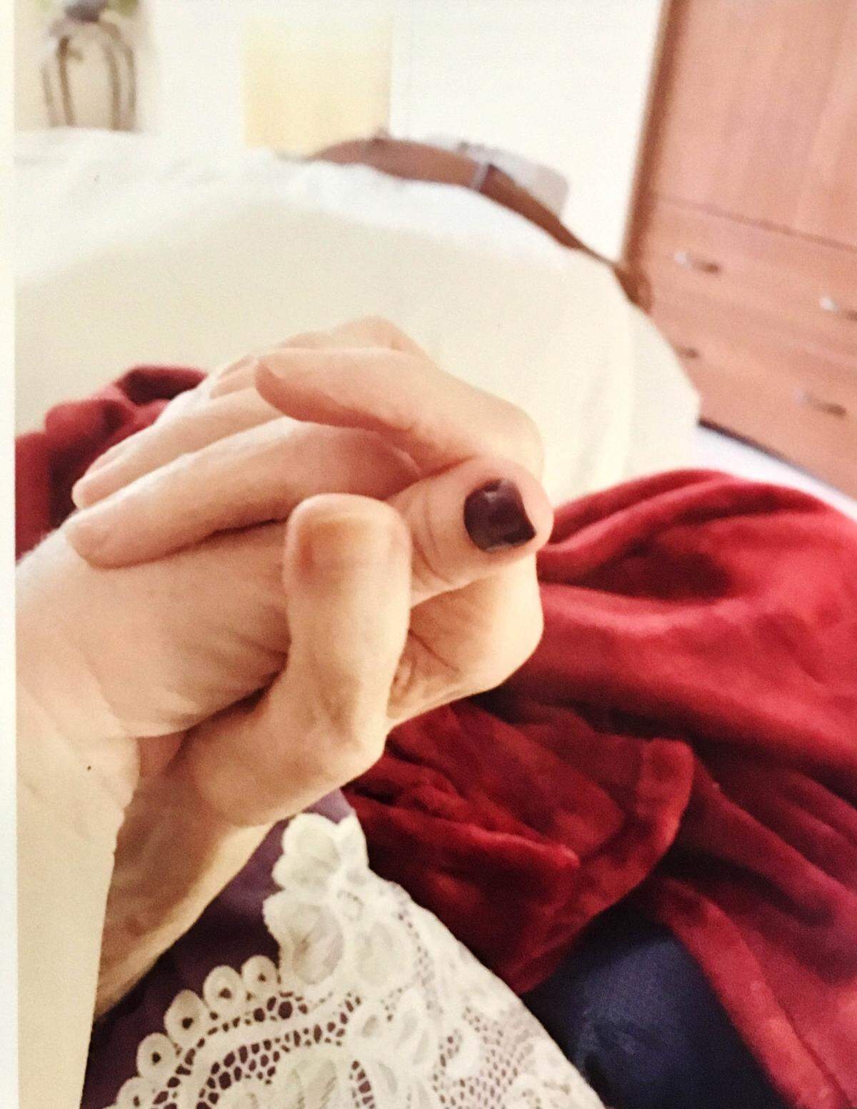 Susan Liuzzo holds the hand of her mother.