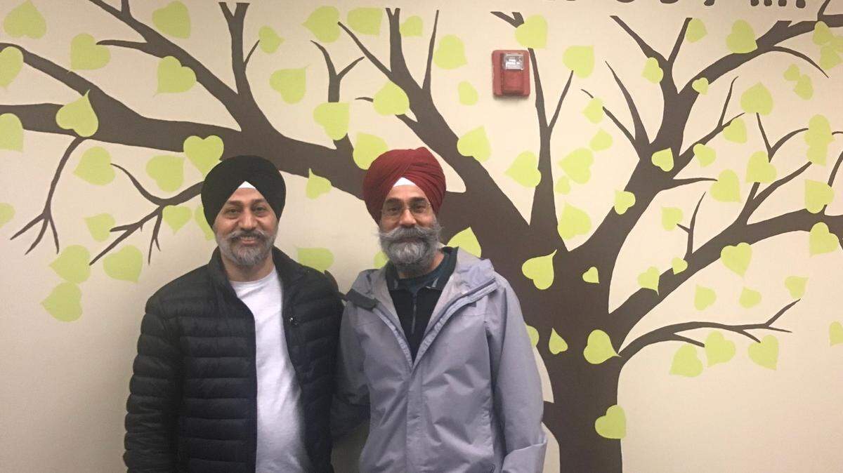 From left: Amardeep Singh and Ajay Partap Singh stand in the music room of the Gurdwara Sahib Khalsa Darbar, Sunday January 22, 2023. The room’s window was broken in one of several incidents of vandalism at the house of worship for the Sikh community in Charlotte.