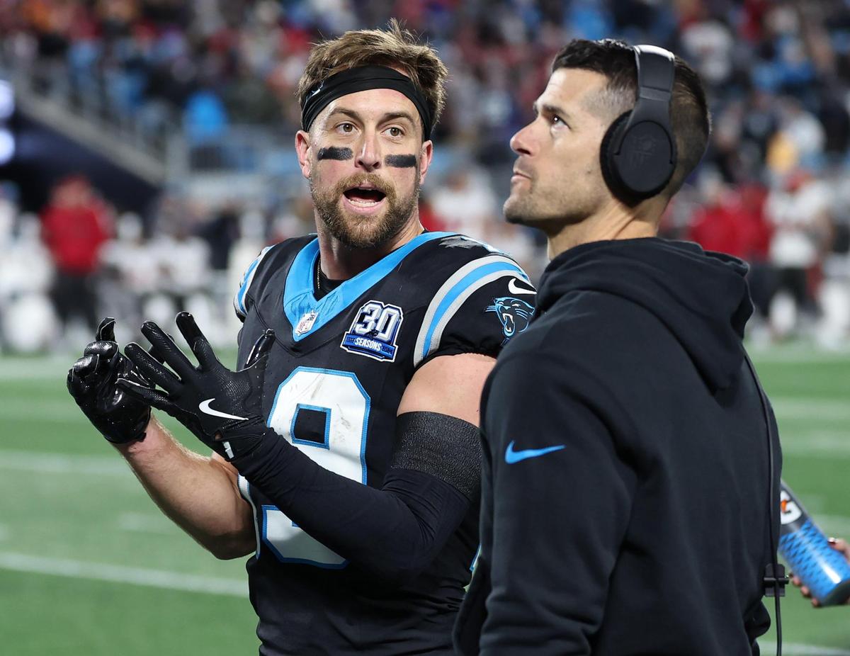 Carolina Panthers wide receiver Adam Thielen, left, speaks with head coach Dave Canales as they watch a replay of Thielen’s touchdown pass reception in the end zone during late first-half action against the Tampa Bay Buccaneers at Bank of America Stadium on Dec. 1, 2024. The play was initially ruled a touchdown and then overturned.