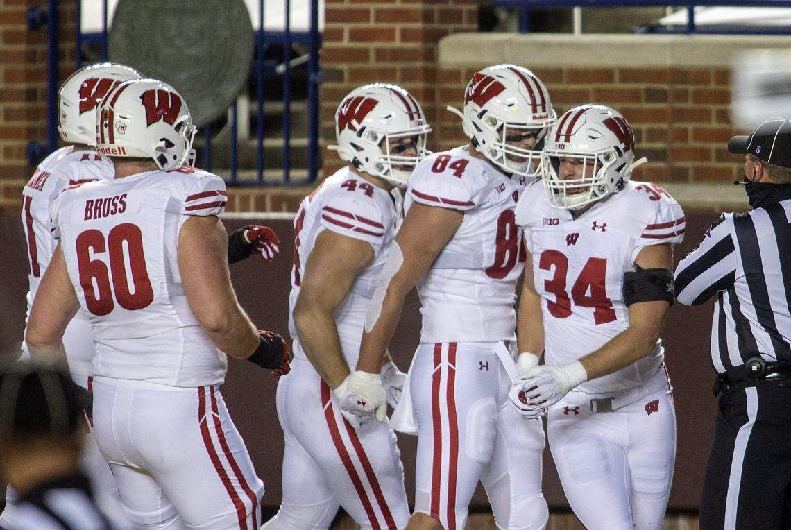 Former Wisconsin fullback Mason Stokke (34) celebrates his touchdown with teammates in the first quarter of an NCAA college football game against Michigan in Ann Arbor, Mich., Saturday, Nov. 14, 2020. (AP Photo/Tony Ding)