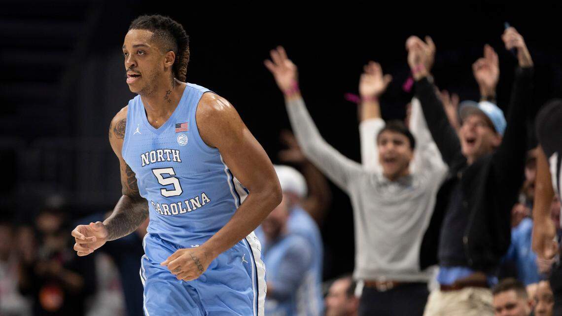 North Carolina fans seated court side celebrate after Armando Bacot (5) sank a three-point basket in the second half against Oklahoma on Wednesday, December 20, 2023 at the Spectrum Center in Charlotte, N.C. UNC beat No. 7 Oklahoma, 81-69.