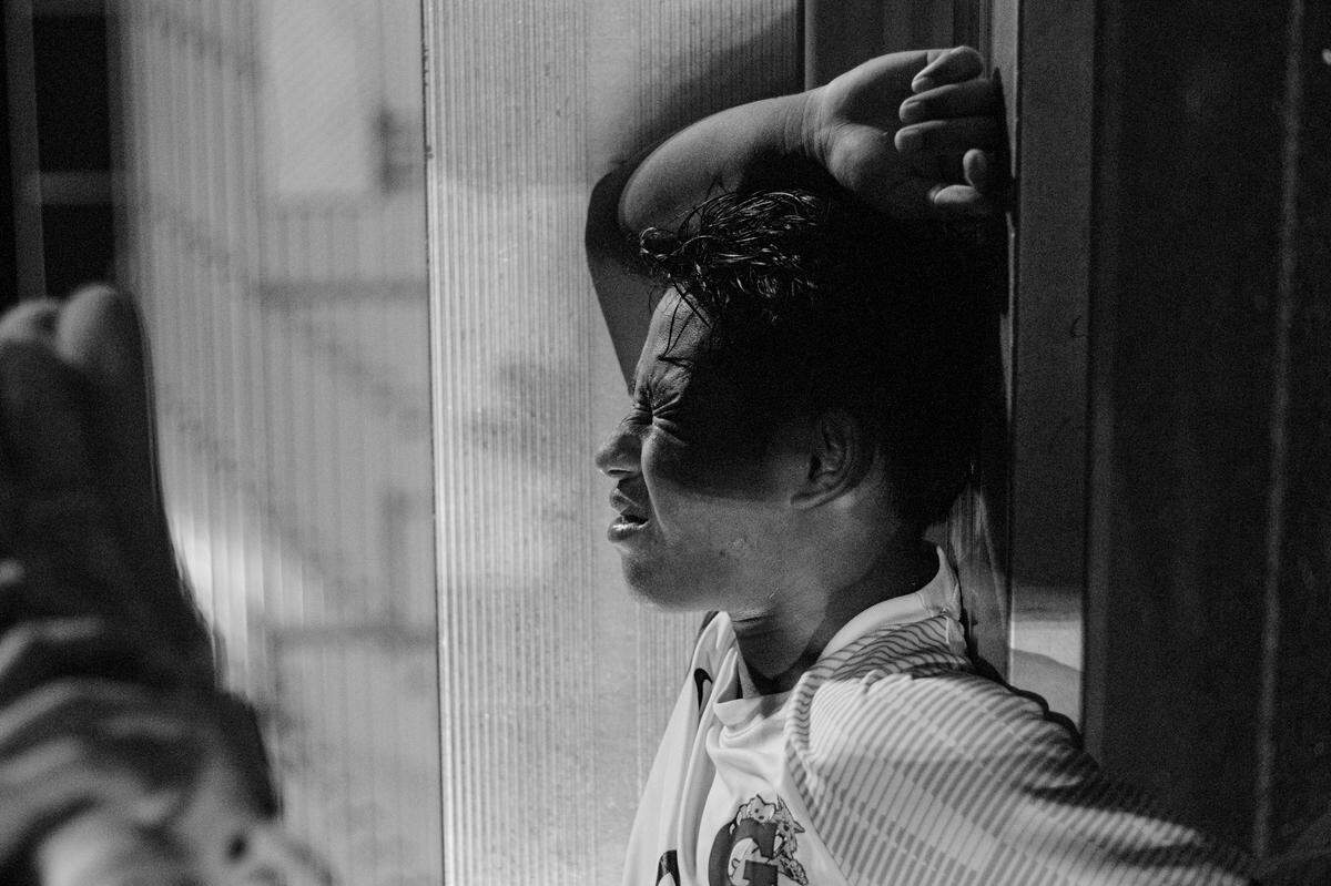 Title: agony of the game Garinger soccer player Sako Mo, winces in agony after being injured in game. Independence High School 10-22-24