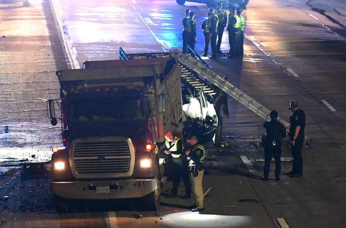 N.C. Highway Patrol officers investigate a fatality along I-85 South near the University Pointe Blvd overpass on Tuesday, January 10, 2023. Four people died in the wreck that closed I-85 South at University City Blvd.