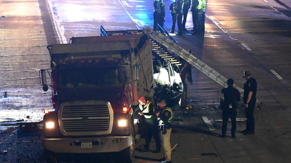 N.C. Highway Patrol officers investigate a fatality along I-85 South near the University Pointe Blvd overpass on Tuesday, January 10, 2023. Four people died in the wreck that closed I-85 South at University City Blvd.