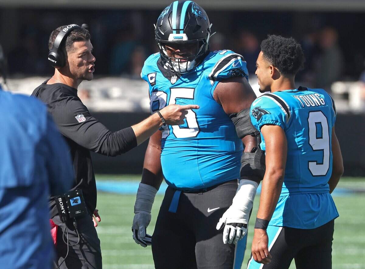 Carolina Panthers head coach Dave Canales, left, speaks with defensive tackle Derrick Brown, center and quarterback Bryce Young, right, during acton against the Tampa Bay Buccaneers at Bank of America Stadium in Charlotte, NC on Sunday, October 25, 2026.