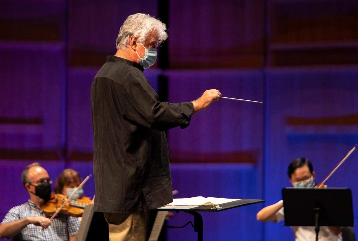 Music director Christopher Warren-Green leads the Charlotte Symphony Orchestra during one of its first indoor rehearsals.