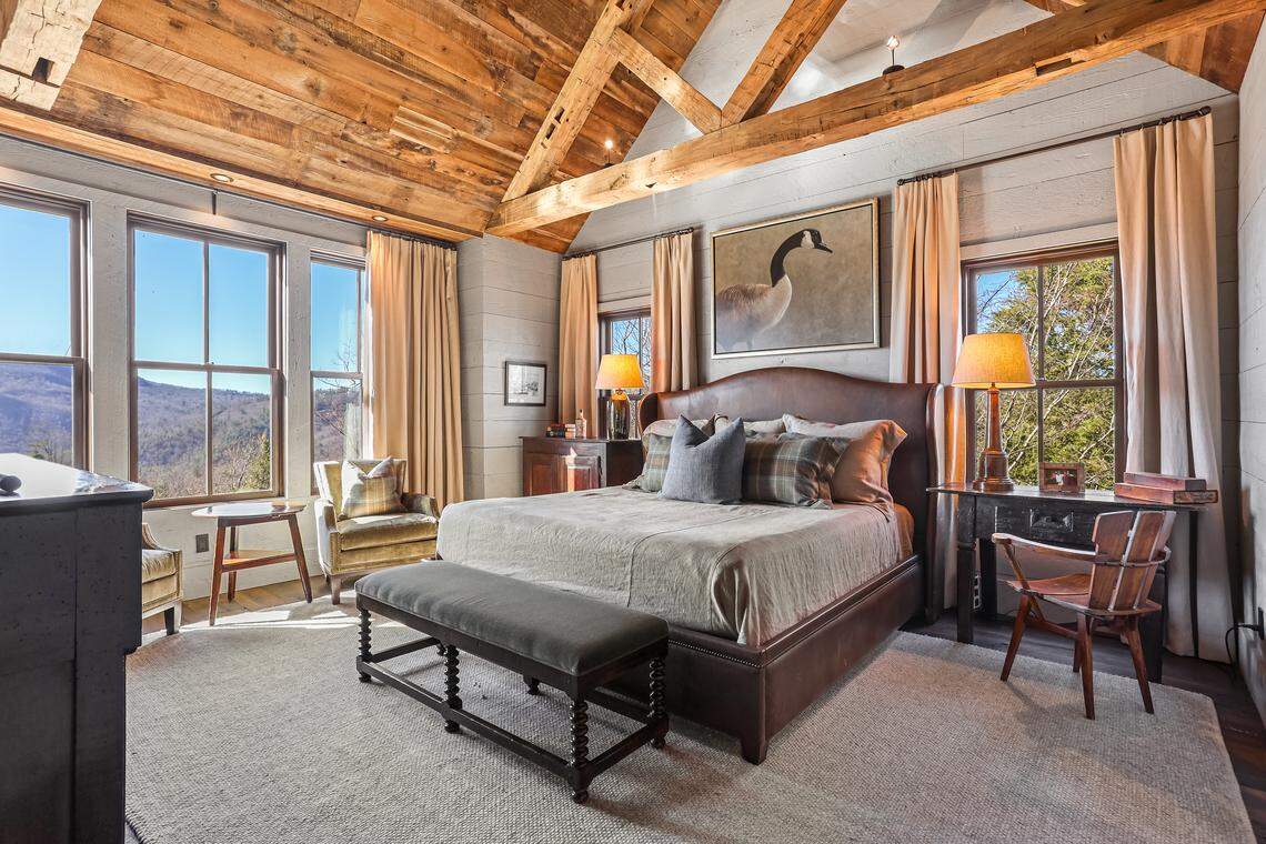 The home includes six bedroom suites, with a primary suite on the main level, four guest suites upstairs, and a bunk room suite on the terrace level.