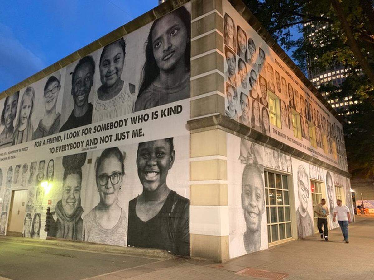 The Charlotte Mecklenburg Main Branch library features portraits of 250 children. Organizers and volunteers from About Face Charlotte started putting up the prints May 9.