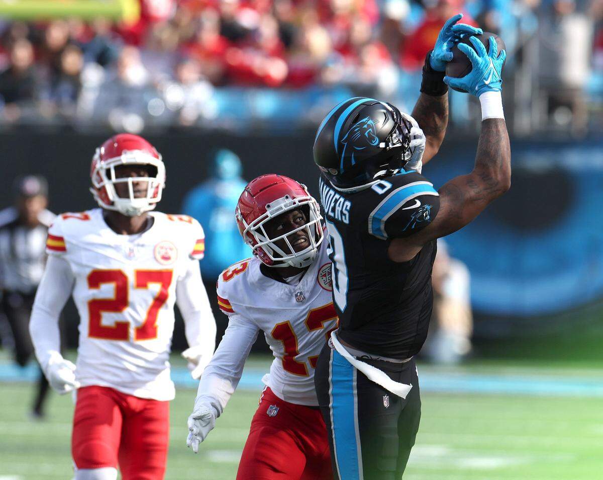 Carolina Panthers wide receiver Ja’Tavion Sanders, right, catches a pass along the sideline as Kansas City Chiefs cornerback Nazeeh Johnson, center, attempts to knock the pass away at Bank of America Stadium in Charlotte, NC on Sunday, November 24, 2024.