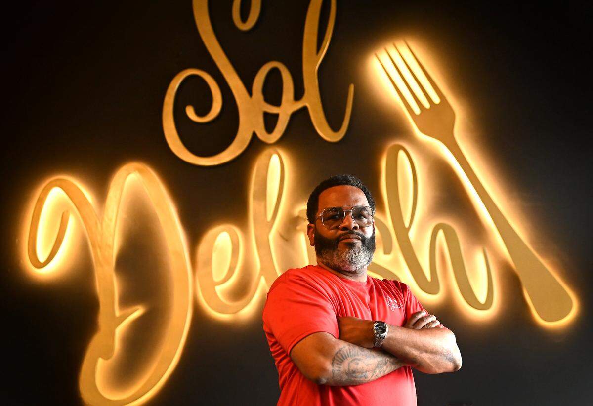 Sol'Delish co-owner Latell Brice on Sunday, March 15, 2026. When Brice and his business partner began looking to move from their tiny nearby space on North Tryon St. to a larger restaurant, they initially considered moving to Steele Creek. A former Charlotte City Council member encouraged them to stay in the University City area helping to connect them with an empty lakefront space at The Boardwalk.