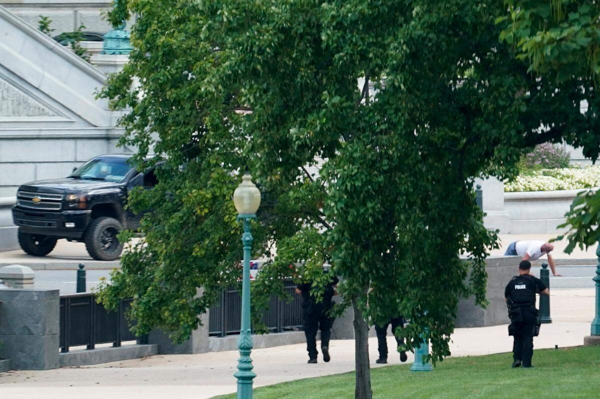 A man, identified as Floyd Ray Rosenberry of Grover, NC, surrenders after being in a pickup truck in front of the Library of Congress near the U.S. Capitol on Thursday, Aug. 19, 2021. Officials evacuated a number of buildings around the Capitol and sent snipers to the area after officers saw a man holding what looked like a detonator inside the pickup, which had no license plates.