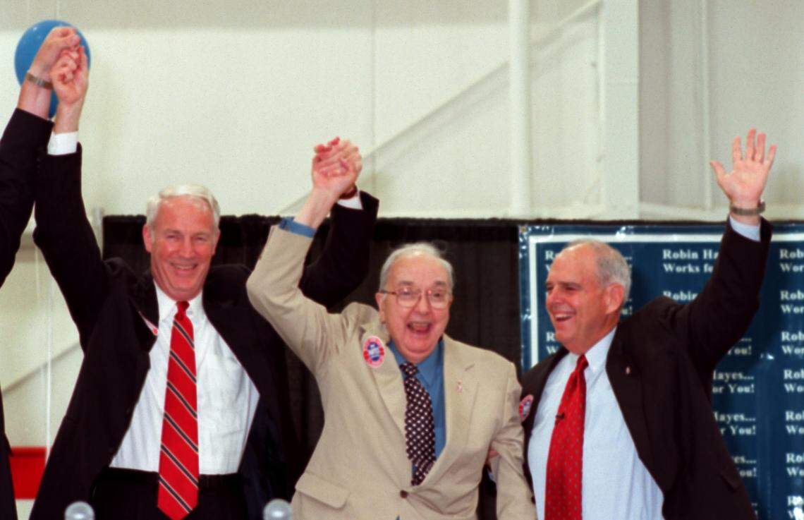 Former Charlotte mayor Richard Vinroot, U.S. Sen. Jesse Helms and Robin Hayes at Spitfire Aviation in Concord in 2000.