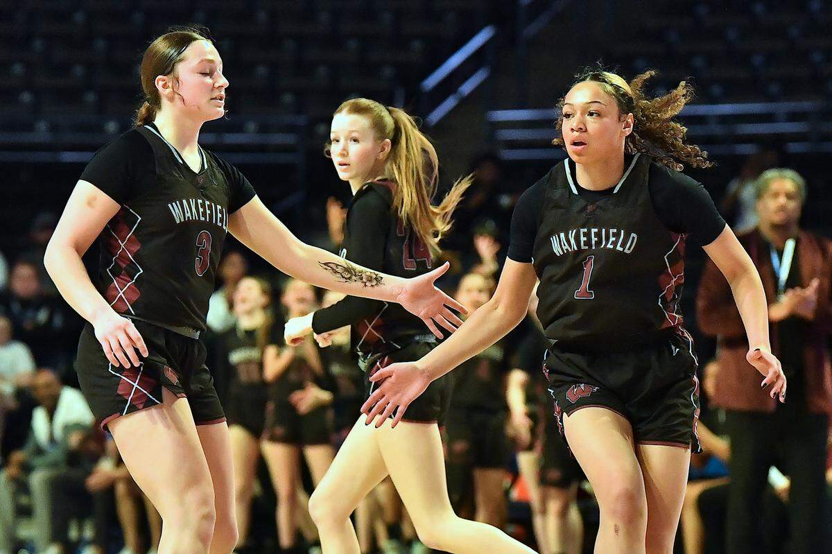 Wakefield’s Nicole Amend (3) congratulates Sydney Conti (1) after her shot against Hoggard in the first half. The Wakefield Wolverines and the Hoggard Vikings met in the NCHSAA 4A East Regional Final in Winston-Salem, N.C. on March 12, 2025.