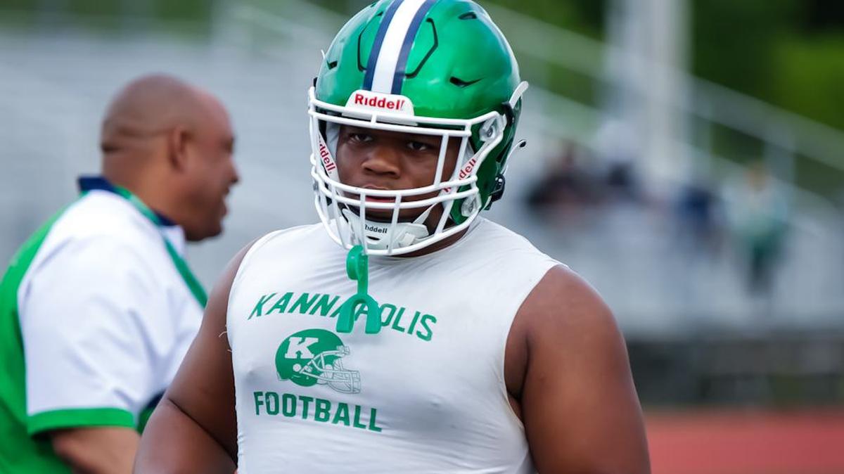 AL Brown lineman Chaz Knox leads his team in defensive drills at the high school football Prospect Day recruiting showcase at Hickory Ridge High School