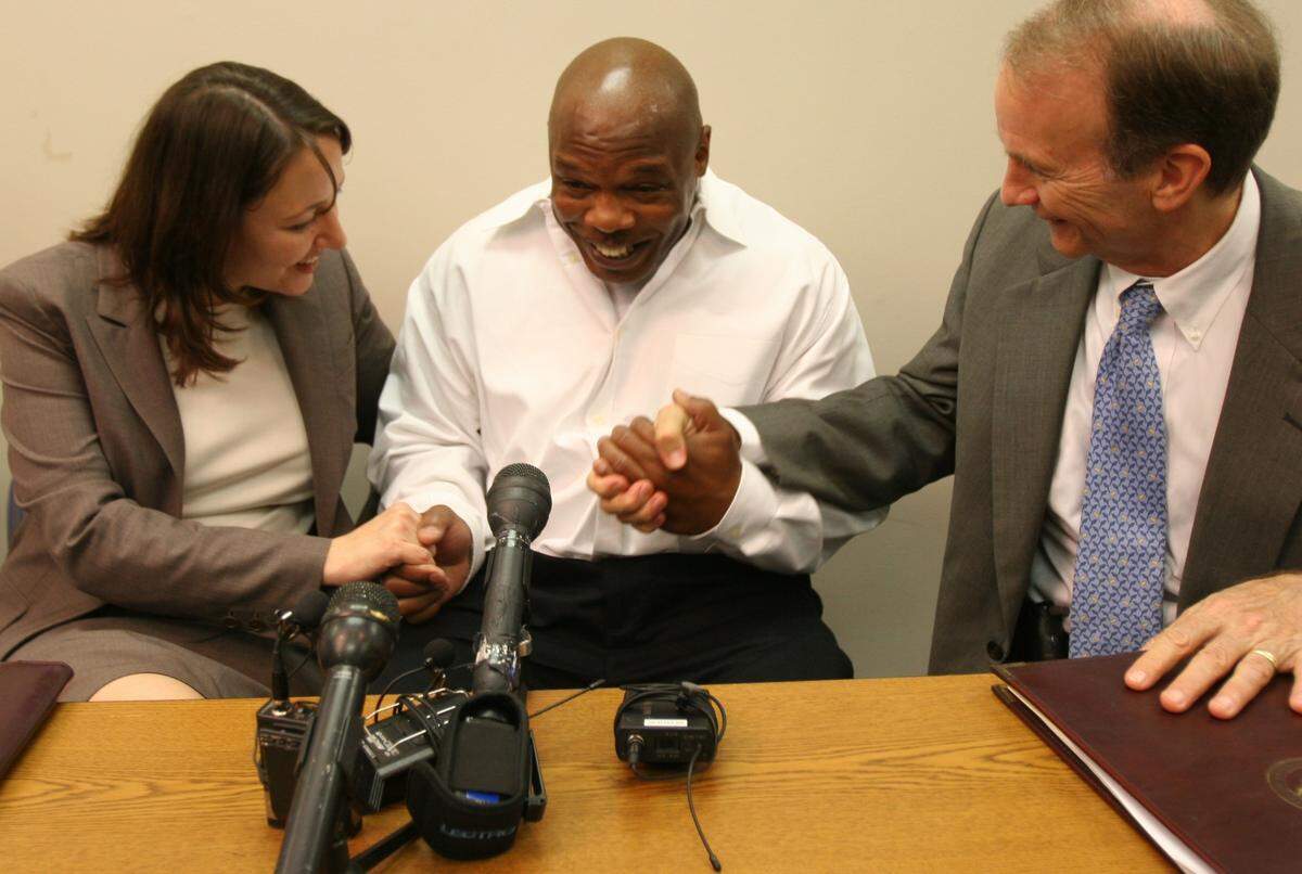 Glen Edward Chapman, center, celebrates with his attorneys Jessica Leaven, left, and Frank Goldsmith at a press conference Wednesday, April 2, 2008. A prosecutor dismissed murder charges against Chapman after a judge found that investigators covered up evidence showing his innocence.
