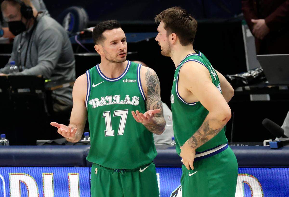 Now an ESPN analyst, then-Dallas Mavericks guard JJ Redick speaks with Luka Doncic (right) during a 2021 game.