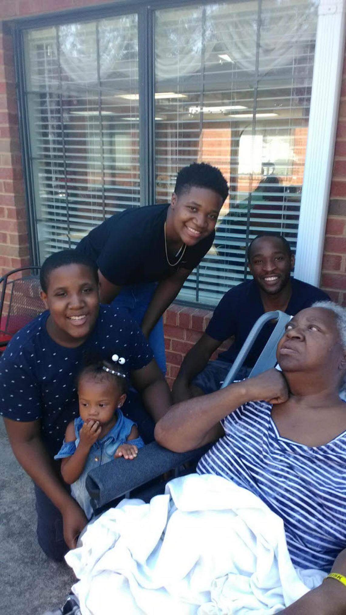 Palestine Howze, shown here in her wheelchair, is surrounded by family members. Howze died at a Durham nursing home for reasons that her family says are unrelated to COVID-19. Her family has sued. But the nursing home has tried to block the suit by claiming protection from North Carolina’s COVID-19 immunity law, which has made it difficult for families to hold nursing homes accountable for neglect.  