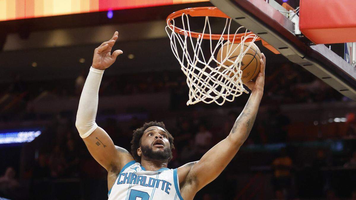 Charlotte Hornets forward Miles Bridges (0) dunks against the Miami Heat during the first half at Kaseya Center.