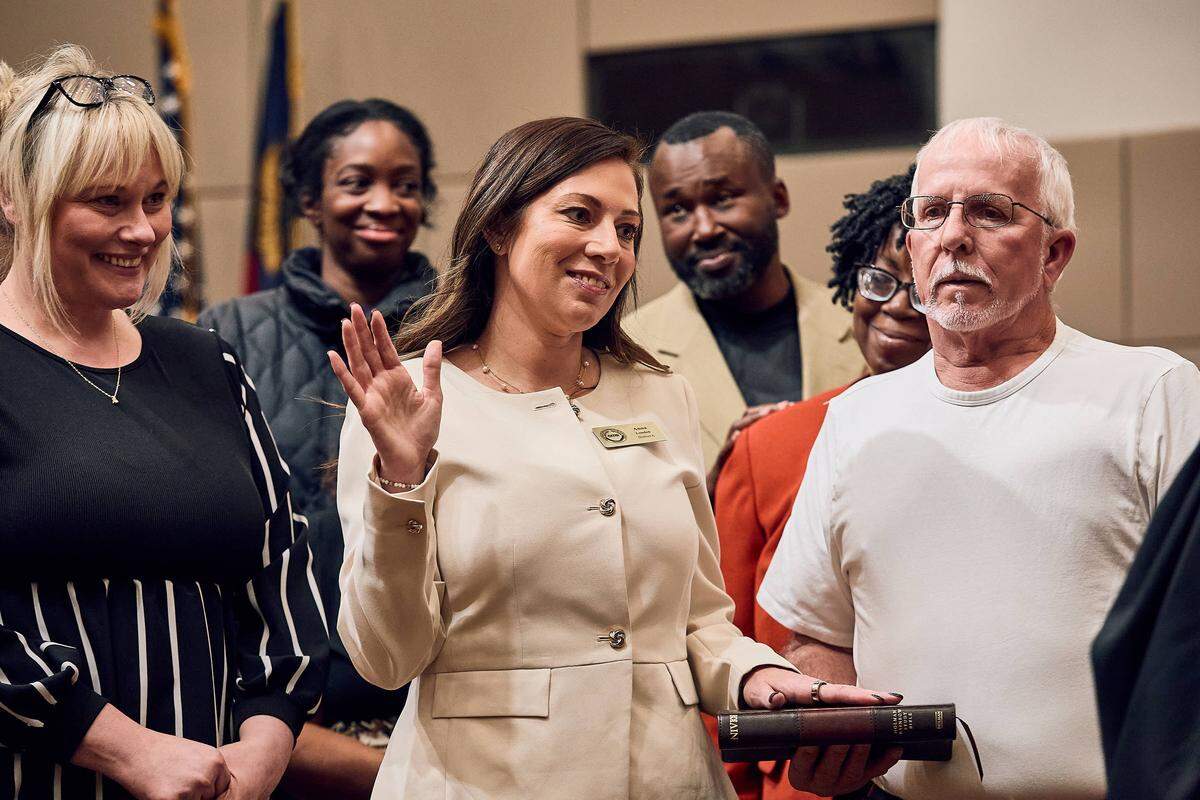 Anna London, the newest board member for Charlotte-Mecklenburg Schools' District 6, is sworn in to her position surrounded by family and friends on December 9, 2025.