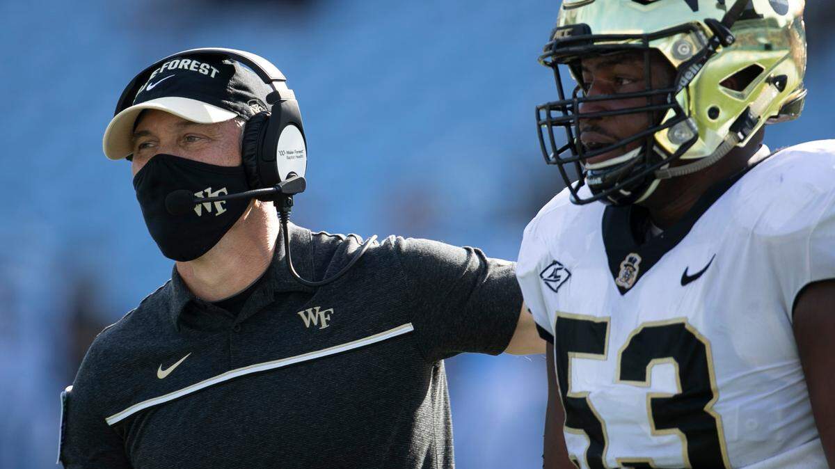 Wake Forest head coach Dave Clawson embraces lineman Je’Vionte’ Nash (53) after a score in the second quarter against North Carolina at Kenan Stadium on Saturday, November 14, 2020 in Chapel Hill, N.C.