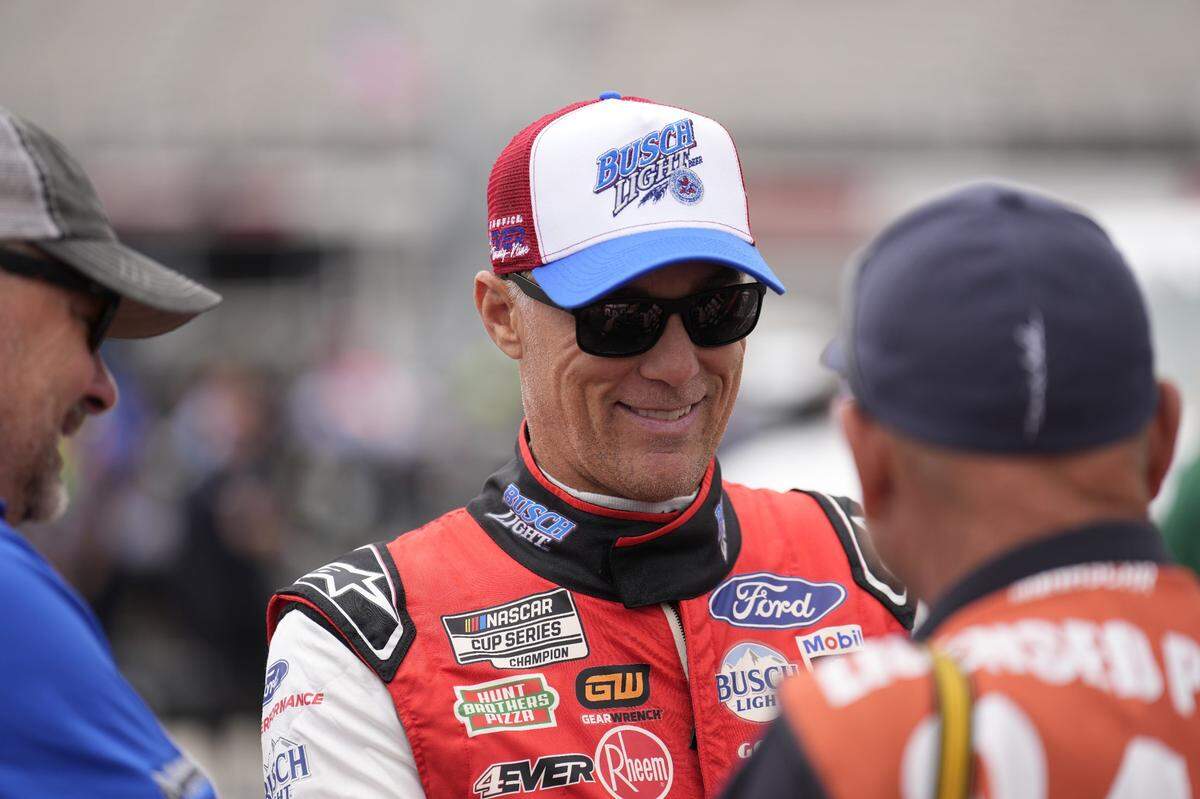 May 21, 2023; North Wilkesboro, North Carolina, USA; NASCAR Cup Series driver Kevin Harvick (4) chats with photographers before recreating a photo from 1996 at North Wilkesboro Speedway when the track closed. Mandatory Credit: Jim Dedmon-USA TODAY Sports