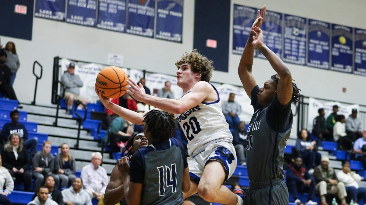 Lake Norman Wildcats Nick Arnold, center, shoots against the Hickory Ridge Ragin’ Bulls at Lake Norman High School in Mooresville, N.C., on Tuesday, February 6, 2024.