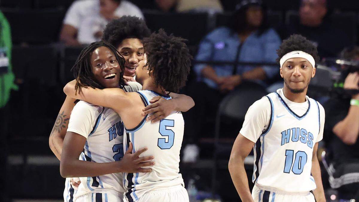 Members of the Hunter Huss boys basketball team begin to celebrate their 103-69 victory over Fike in the NCHSAA 5A boys championship game on Saturday, March 14, 2026 at Lawrence Joel Veterans Memorial Coliseum in Winston-Salem, NC. 