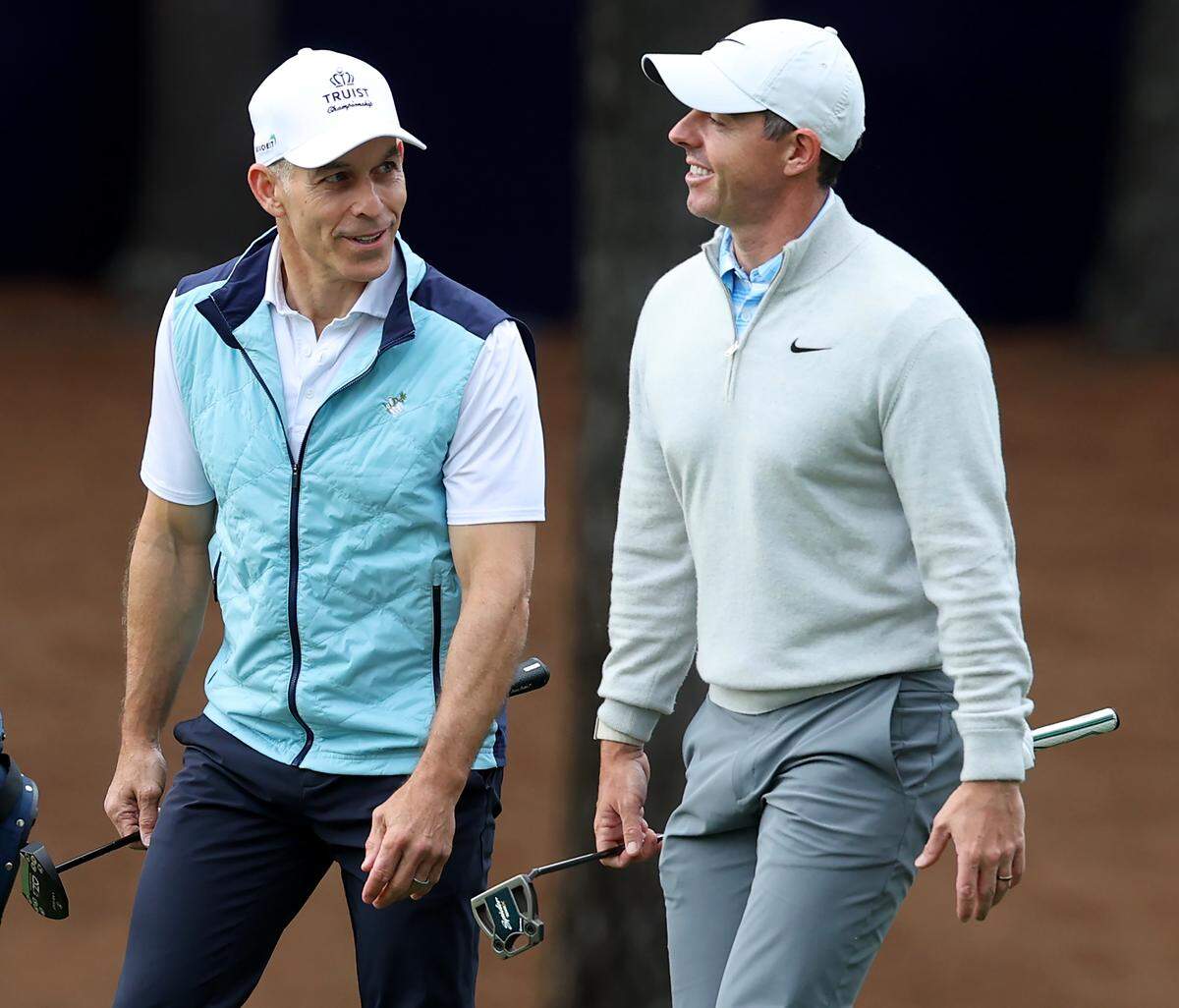 Charlotte Hornets co-owner Rick Schnall, left and golfer Rory McIlroy, right, talk as they walk down the second fairway during the Truist Championship Pro-Am at Quail Hollow Club in Charlotte, NC on Wednesday, May 6, 2026. Schnall was part of the amateur team playing with McIlroy for nine holes. 