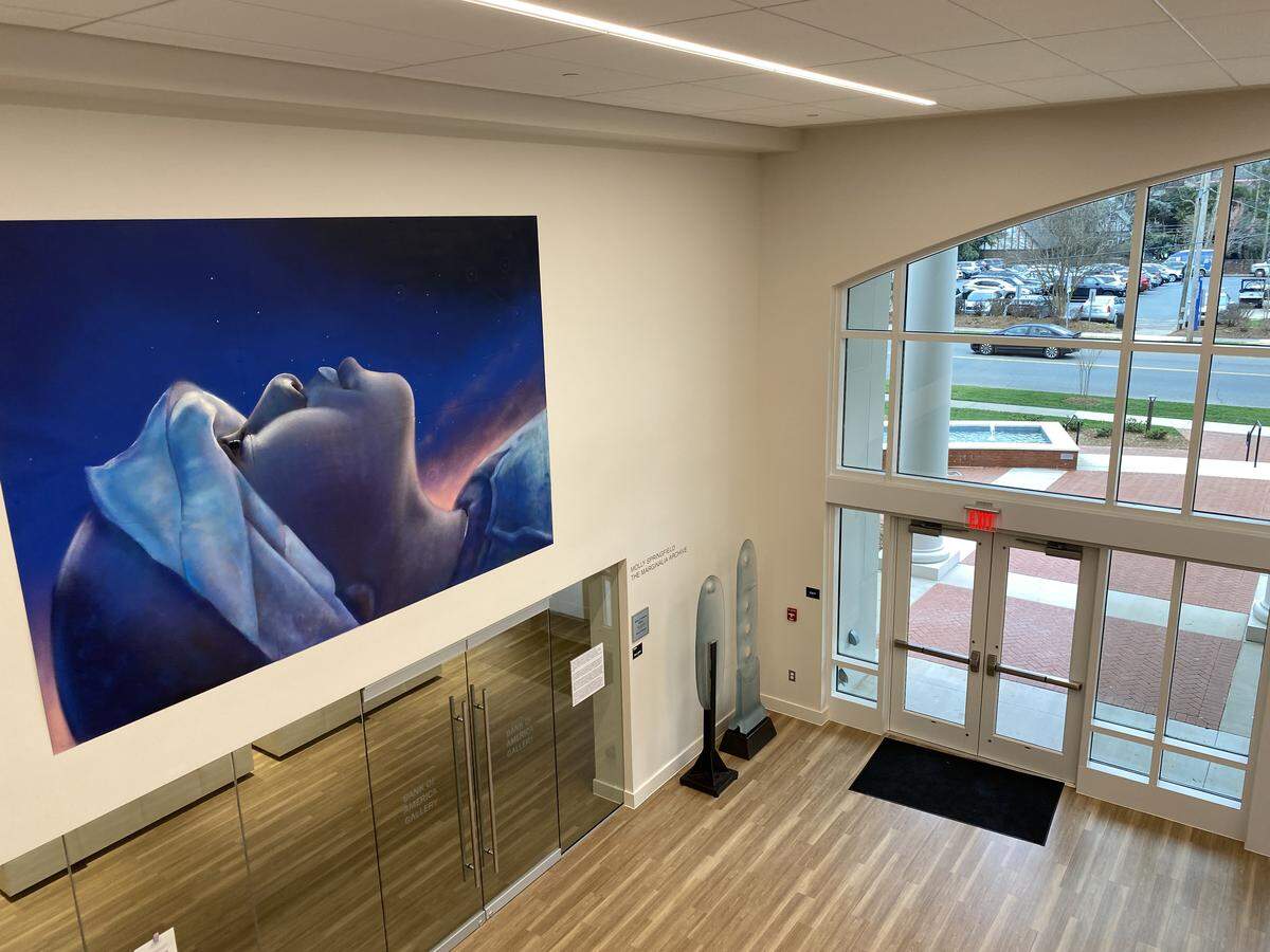A mural by Charlotte artist Nick Napoletano, one of two in the new lobby of the Sarah Belk Gambrell Center for the Arts and Civic Engagement, is designed to provoke thought and discussion about struggles with upward mobility and inequity in Charlotte.