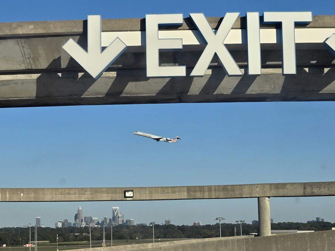 An American Eagle regional jet departs Charlotte Douglas International Airport, soaring above the daily parking deck. Starting March 1, the airport will implement an increase in parking rates.