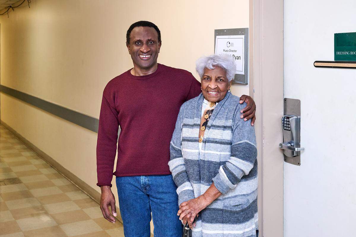 Outside Kwamé Ryan’s dressing room at Belk Theater, with his mother, Joya Gomez of Trinidad, following the Tchaikovsky 5 performance in Charlotte on Feb. 13, 2026. Ryan said his mom was the one who backed his dream of being a conductor from the start.&nbsp;