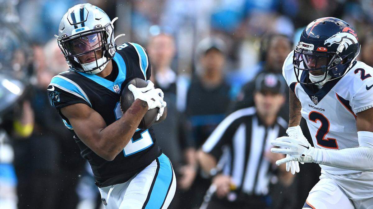 Carolina Panthers wide receiver DJ Moore, left, catches a deep pass from quarterback Sam Darnold during second half action as Denver Broncos cornerback Pat Surtain, right, chases on Sunday, November 27, 2022 at Bank of America Stadium in Charlotte, NC. The Panthers defeated the Broncos 23-10.