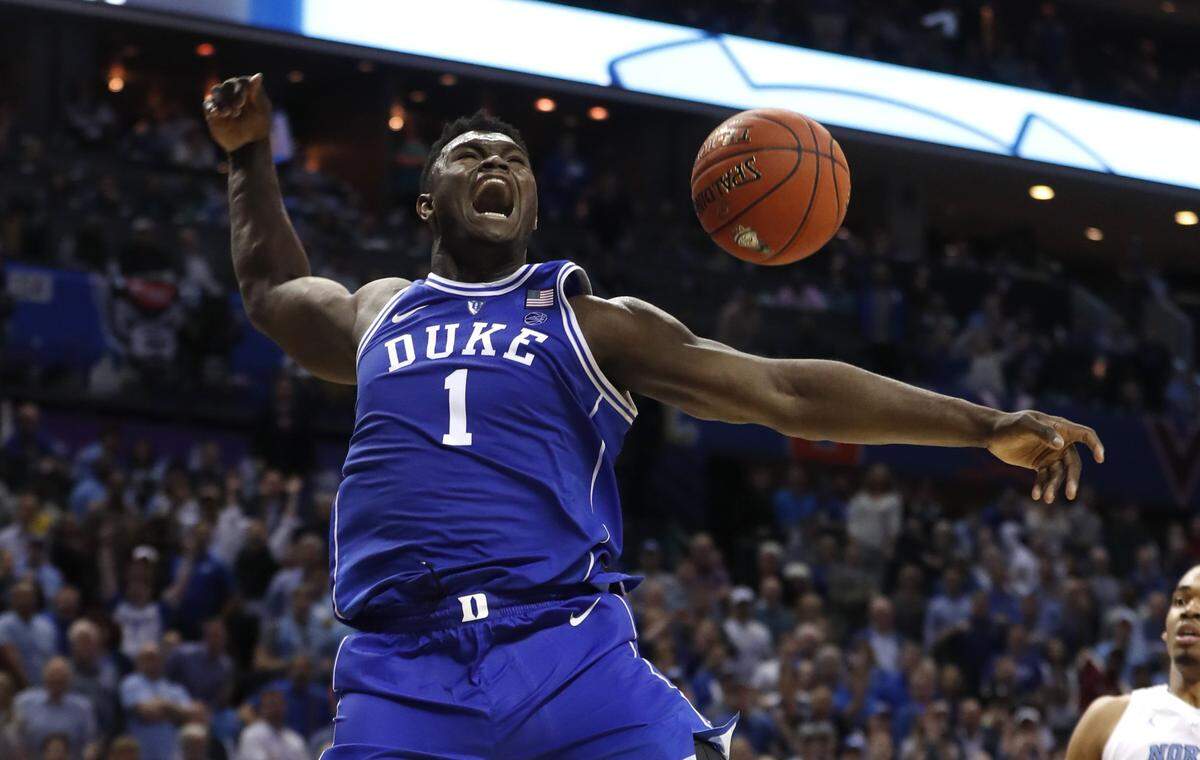 Duke’s Zion Williamson (1) celebrates after slamming in two during the second half of Duke’s 74-73 victory over UNC in the semifinals of the ACC Tournament in Charlotte on Friday.