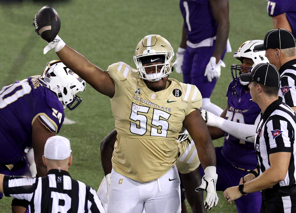 Charlotte 49ers defensive lineman Colin Coates celebrates his recovery of a James Madison University fumble during action on Saturday, August 31, 2024 at Jerry Richardson Stadium.