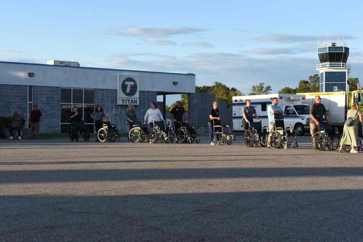 Staff with the company ALG Senior and volunteer nurses waited for nursing home residents from Burnsville, N.C., to arrive by helicopter in Hickory on Tuesday, Oct. 1, 2024. The helicopters are flown by volunteer pilots.