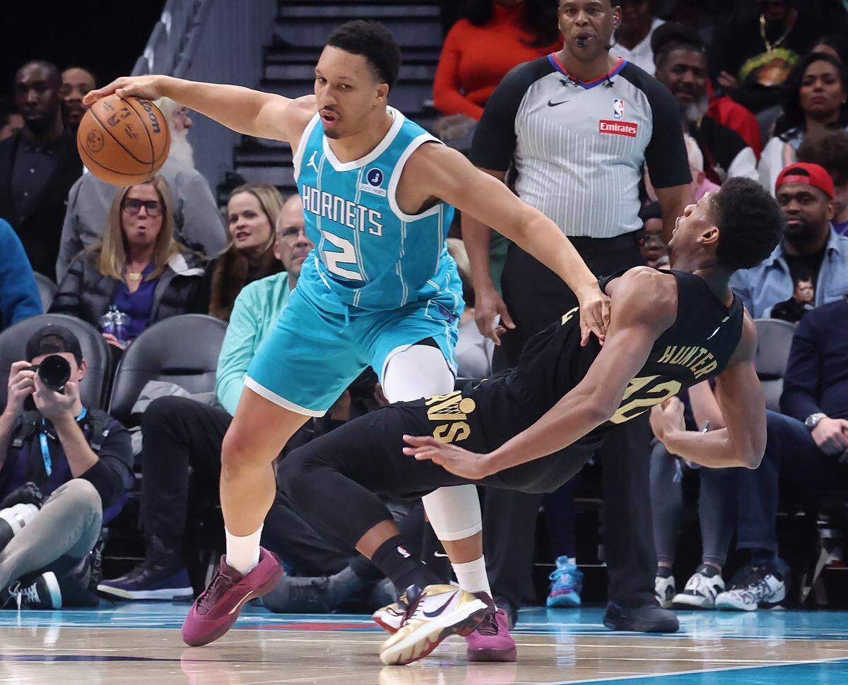 Charlotte Hornets forward Grant Williams, left, pushes off Cleveland Cavaliers forward De’Andre Hunter during action at Spectrum Center in Charlotte, North Carolina, on Wednesday, Jan. 21, 2026. Williams was called for a foul on the play.