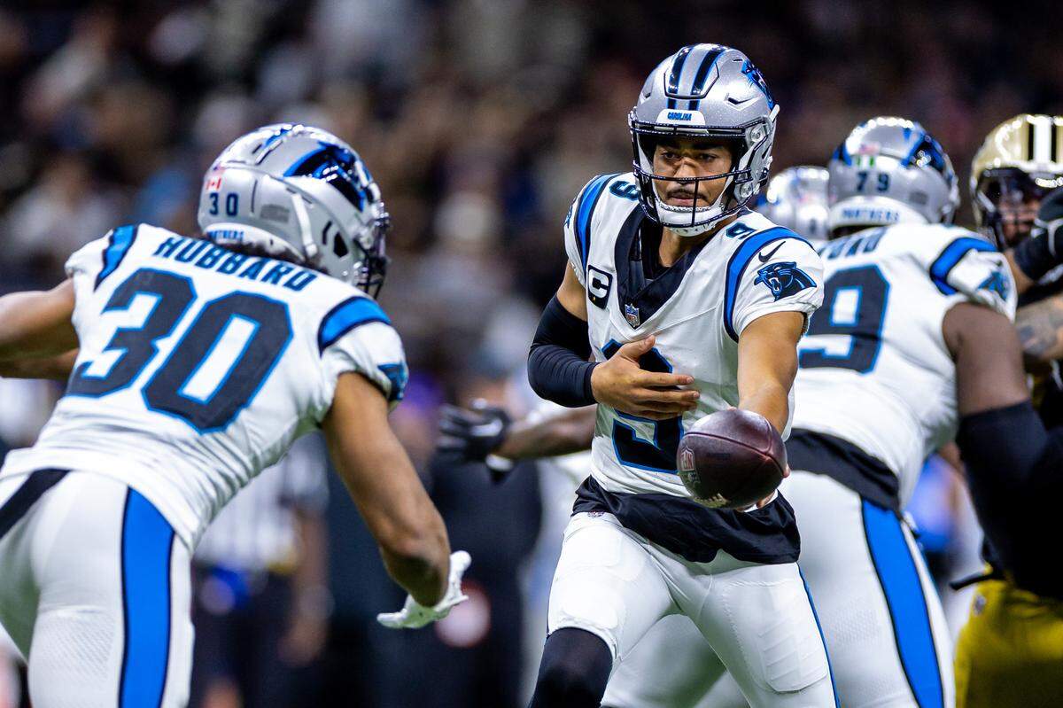 Carolina Panthers quarterback Bryce Young (9) hands the ball off to running back Chuba Hubbard (30) against the New Orleans Saints during the first half at the Caesars Superdome.