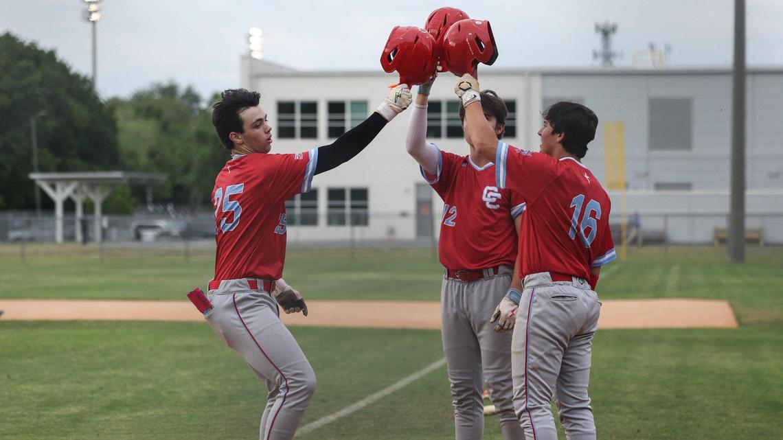 Catholic’s Alex Hoffman , left, celebrates a home run with teammates as he runs across home plate during the Southwestern 4A championship baseball game at Garinger High School in Charlotte, NC on Thursday, May 1, 2025.
