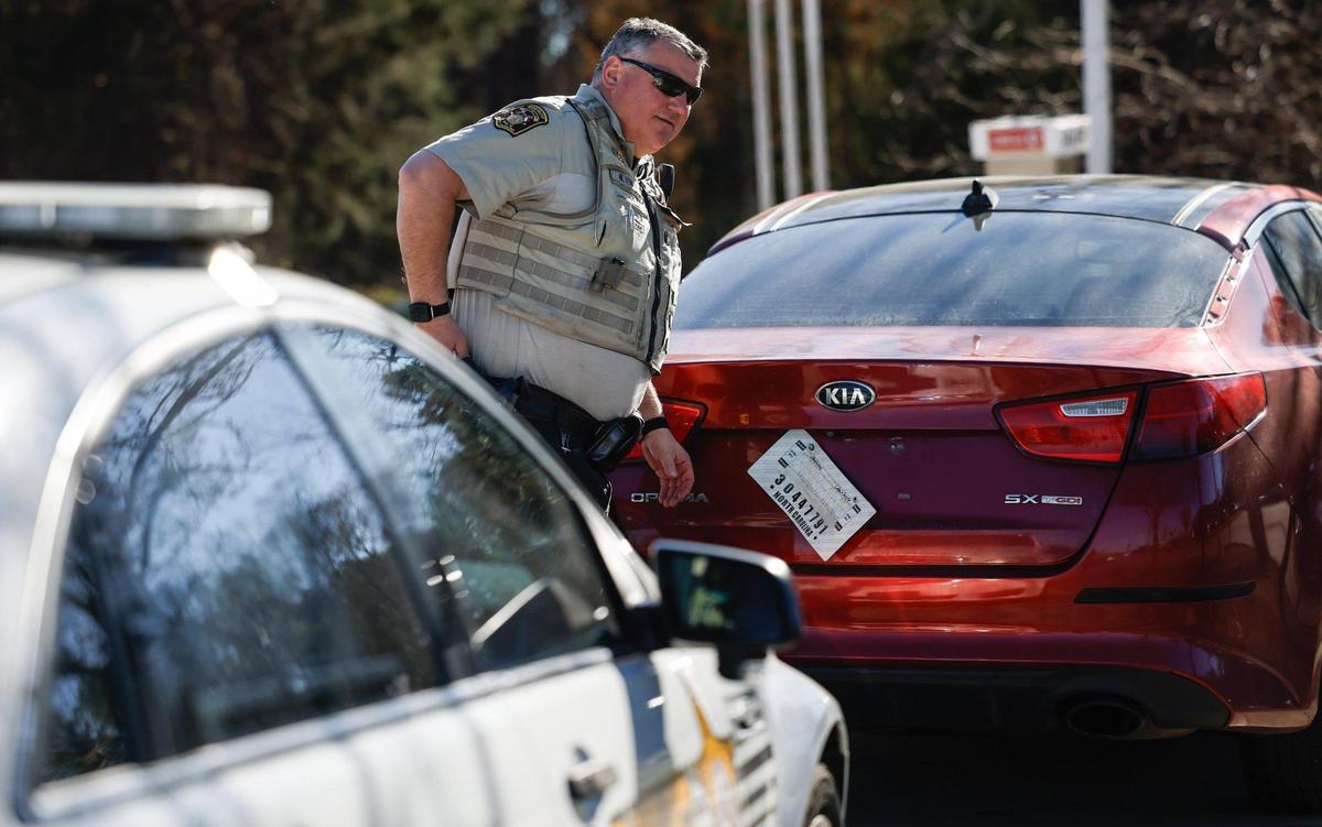 Union County Sheriff Deputy Michael Kenary removes an expired temporary tag from a car that was pulled over in Indian Trail, NC on Friday, February 28, 2025.