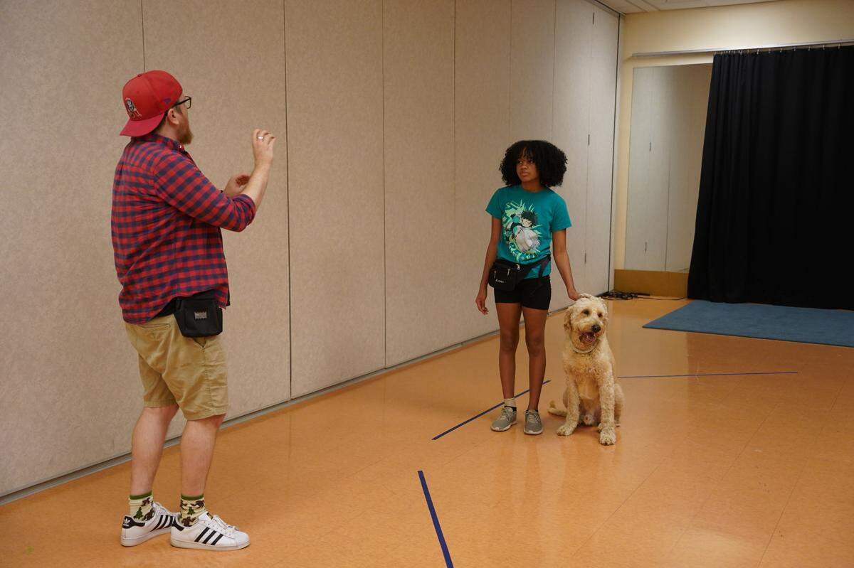 Animal handler Tyler Garstka coaches Anaiah Jones, one of two girls who alternates as Annie. Both Annies alternate spending time with Bailey, who plays Annie’s dog Sandy, to build rapport and train together.