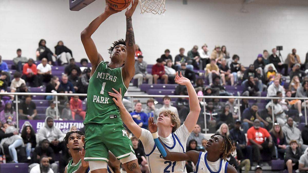 Myers Park’s Sadiq White Jr. (1) takes the shot against Garner’s Lucas Dowless (21) and Ghabrial Scott (12) during the first half at The John Wall Holiday Invitational in Raleigh, N.C. on December 27, 2023.