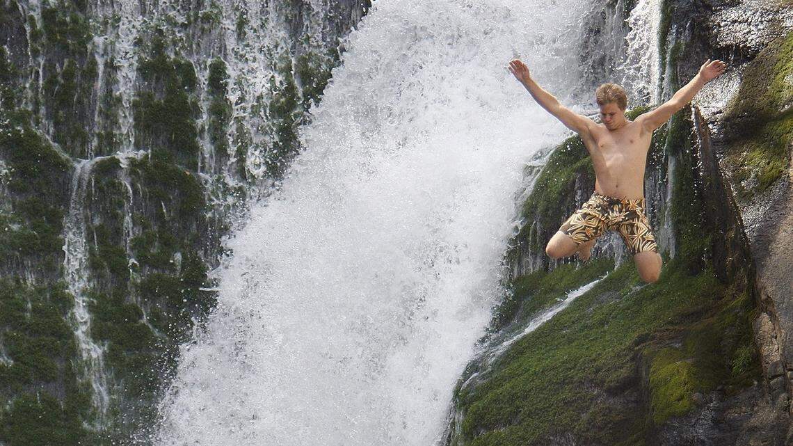 In this 2008 file photo, a 21-year-old man leaps from the 45-foot ledge into the pool at Elk Falls on the Elk River in
Avery  County. The U.S. Forest Service urged people to avoid the falls on Memorial Day weekend, 2018, as treacherous waters forced a  search for a body to be suspended last week. A body believed to be that of 26-year-old Thomas McCardle Jr. surfaced on Wednesday, the sheriff's office said.